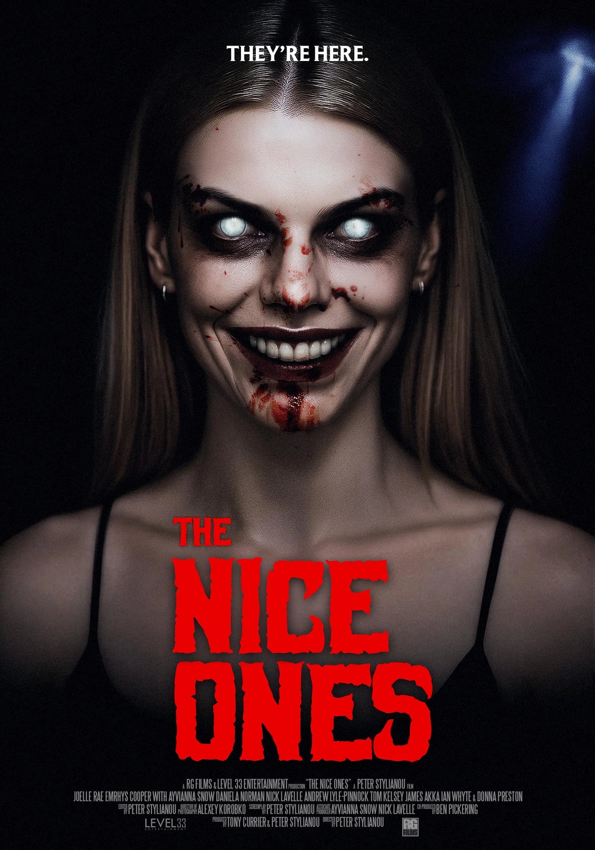The Nice Ones horror poster showing a smiling woman with glowing white eyes