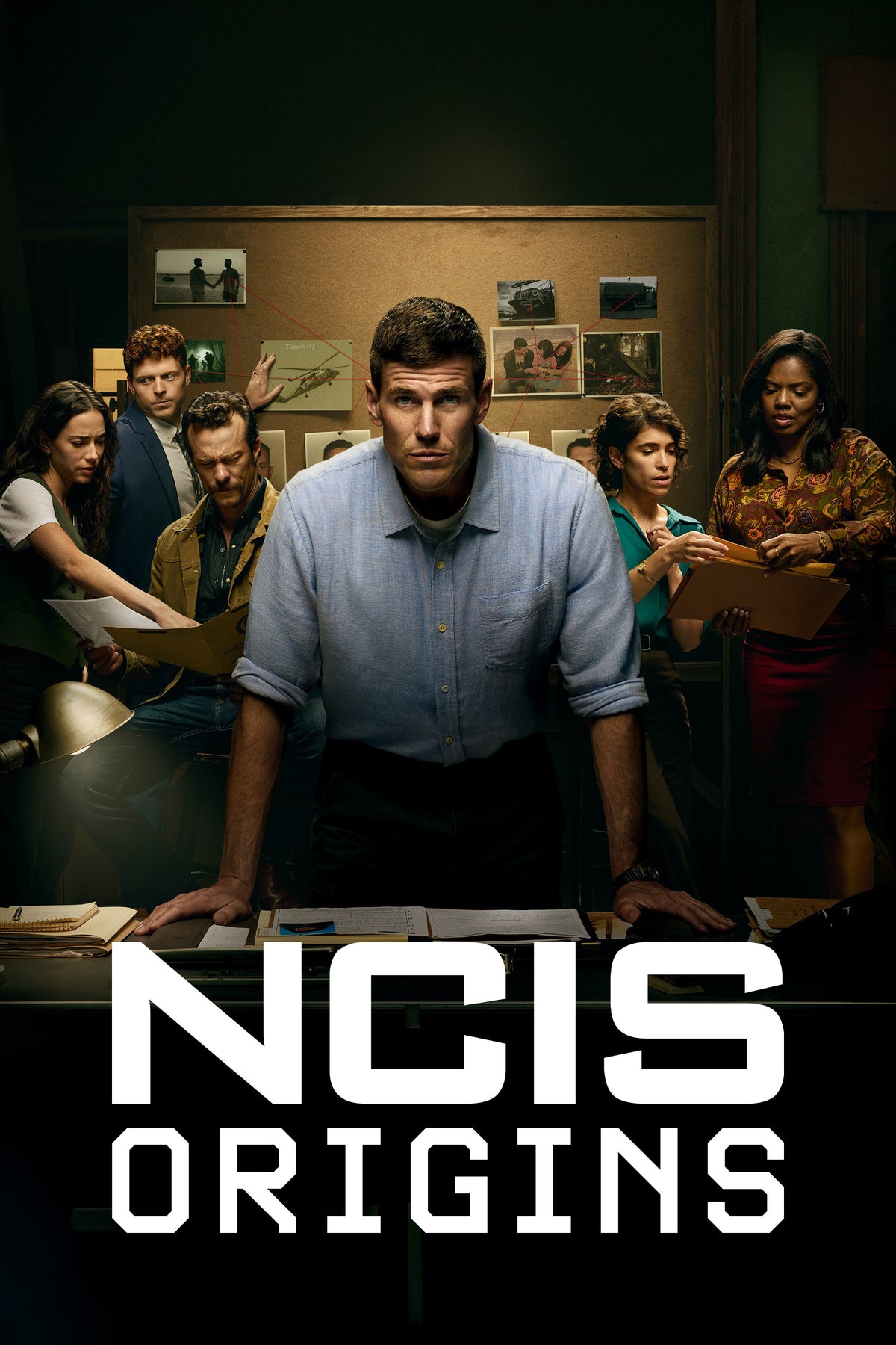 NCIS Origins poster with young Gibbs and his investigative team gathered around a desk.