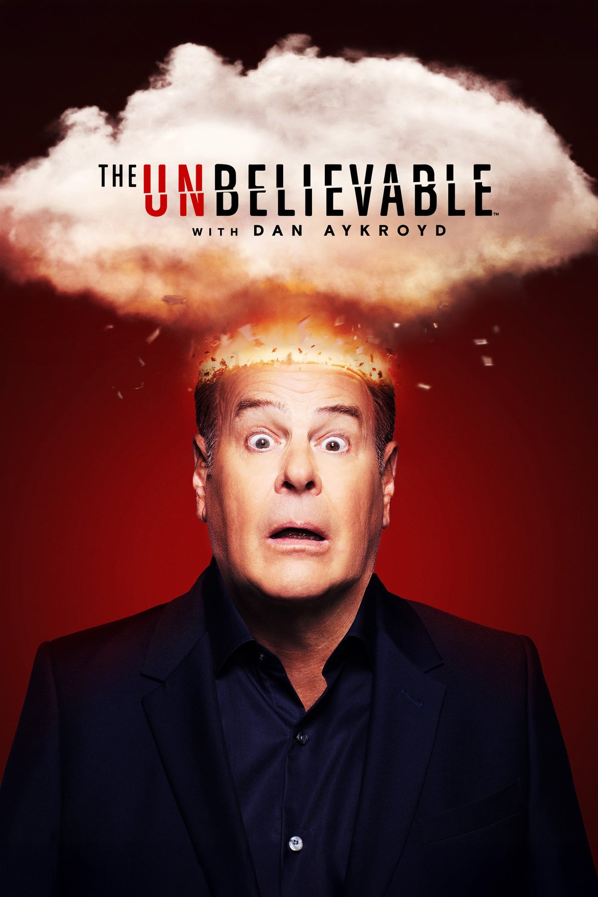 The UnBelievable with Dan Aykroyd poster, with Dan Aykroyd beneath an explosive cloud on a red background.